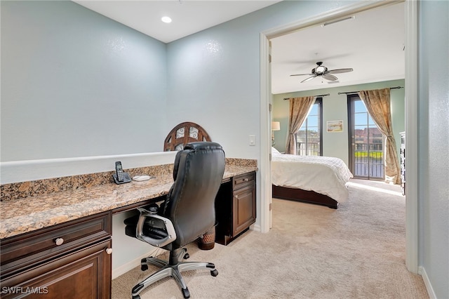 bedroom featuring access to outside, ceiling fan, light carpet, and built in desk