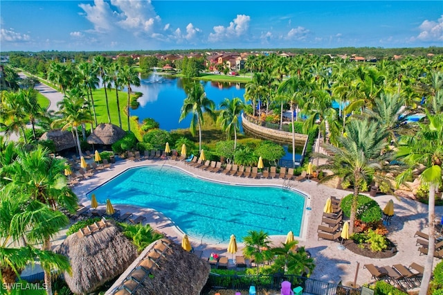 view of swimming pool with a patio area and a water view