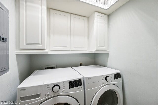 laundry area with cabinets and washing machine and clothes dryer