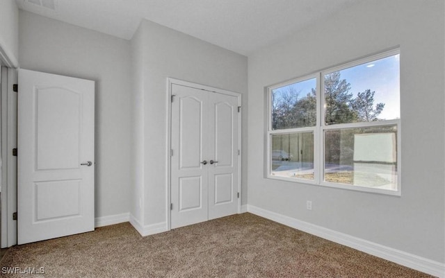 unfurnished bedroom with a closet and carpet