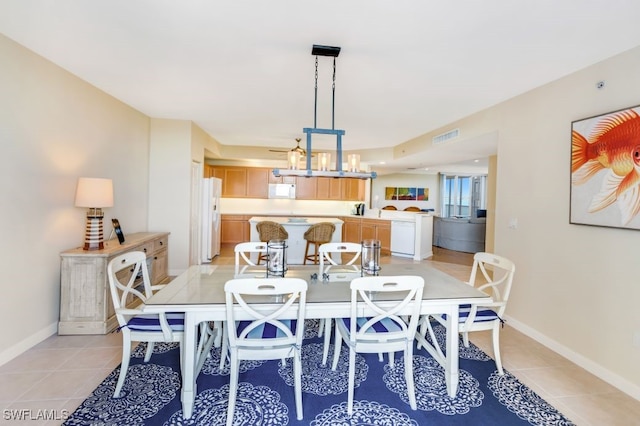 tiled dining space with ceiling fan