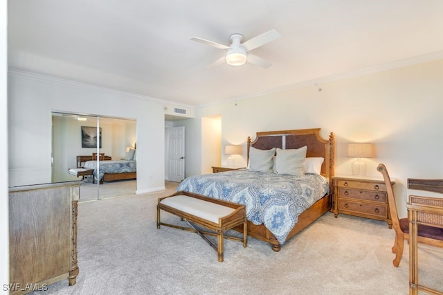 bedroom with crown molding, light carpet, a closet, and ceiling fan