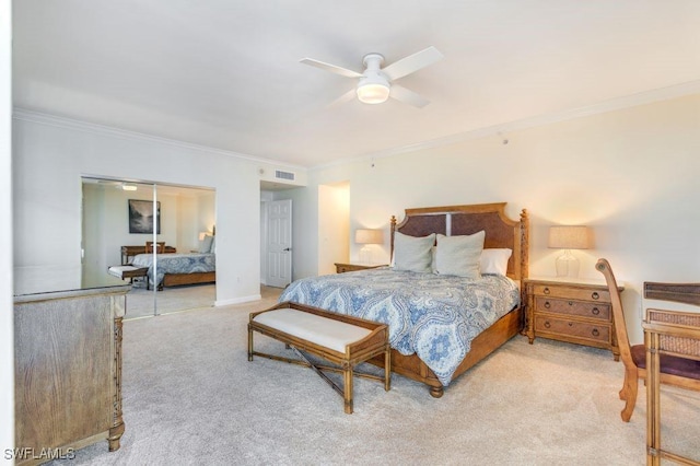 carpeted bedroom featuring baseboards, visible vents, ceiling fan, crown molding, and a closet