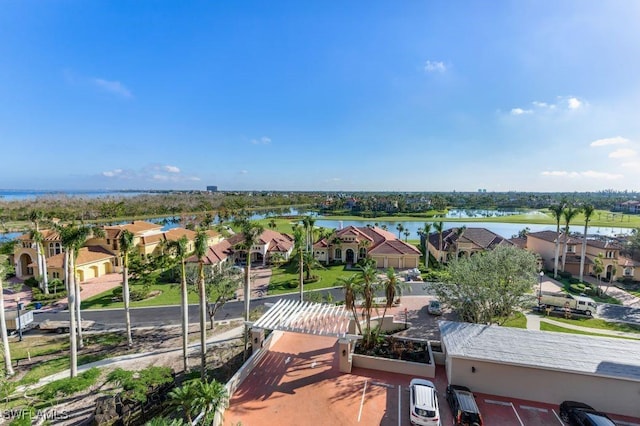 drone / aerial view featuring a water view and a residential view