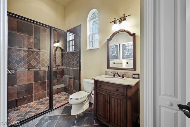 bathroom with vanity, toilet, and walk in shower