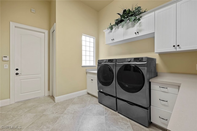 laundry room with cabinets and washing machine and clothes dryer