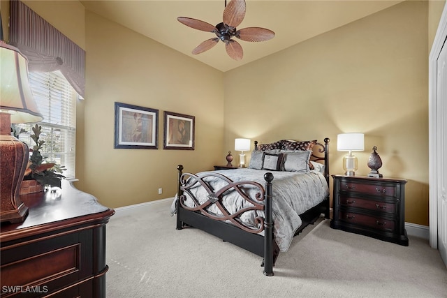 bedroom with light carpet, vaulted ceiling, and ceiling fan