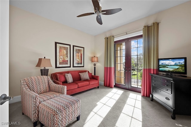 living room with light carpet, french doors, and ceiling fan