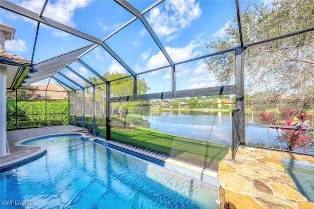 view of pool featuring a patio area, a water view, and glass enclosure