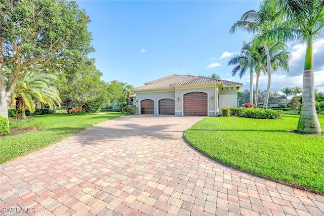 mediterranean / spanish-style house with a front yard and a garage