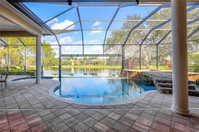 view of pool featuring a patio area, pool water feature, a water view, and a lanai