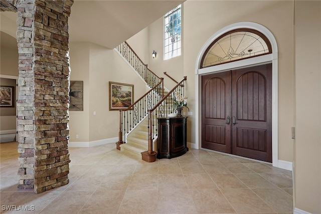 foyer entrance featuring a high ceiling and light tile patterned floors