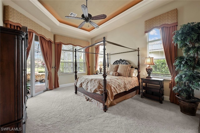 bedroom with ceiling fan, light carpet, multiple windows, and access to exterior