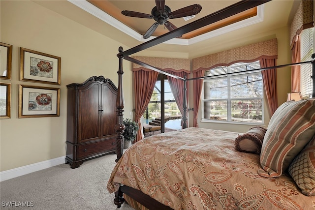 carpeted bedroom featuring crown molding, access to exterior, a tray ceiling, and ceiling fan