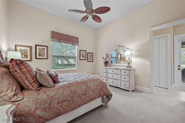 bedroom featuring a closet, ceiling fan, light carpet, and access to outside