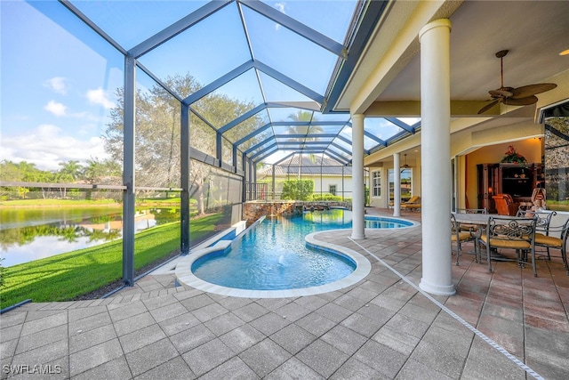 view of swimming pool featuring a patio, a lanai, a water view, and ceiling fan