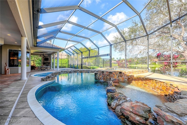 view of swimming pool with a patio, a lanai, ceiling fan, and pool water feature