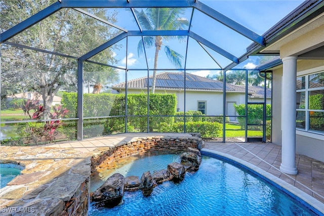 view of swimming pool with a patio and glass enclosure