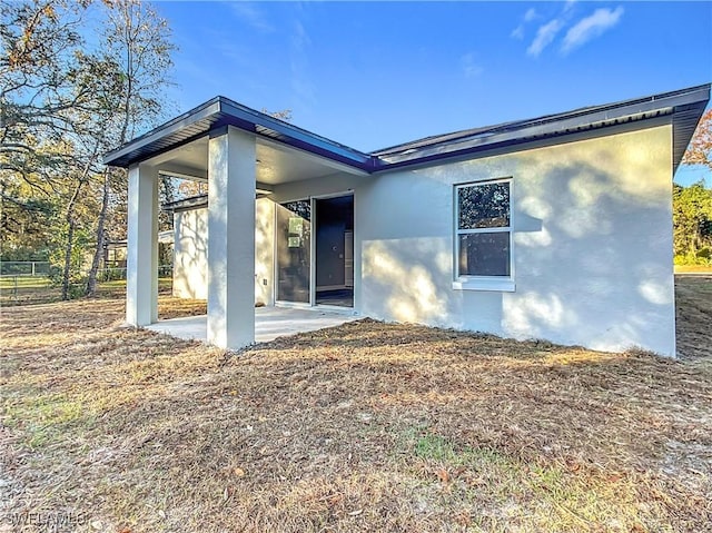 back of property featuring a patio