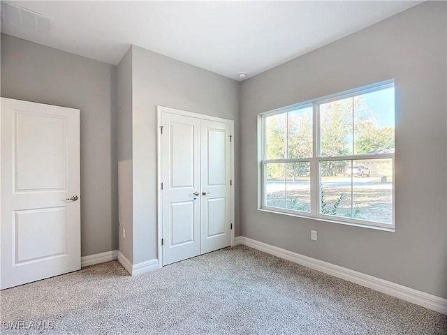 unfurnished bedroom with a closet and carpet