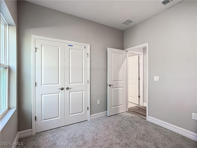 unfurnished bedroom featuring a closet and carpet