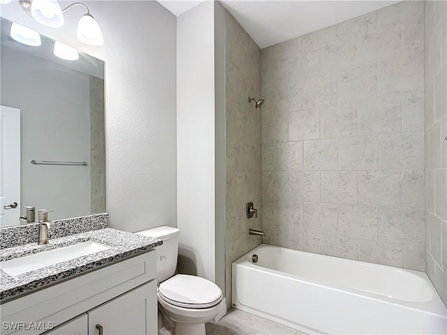 full bathroom featuring tiled shower / bath, vanity, and toilet