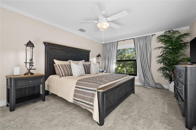 bedroom with light colored carpet and ceiling fan