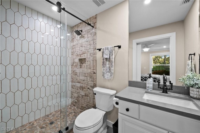 bathroom featuring vanity, toilet, and a shower with shower door