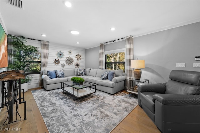 living room with hardwood / wood-style flooring and ornamental molding