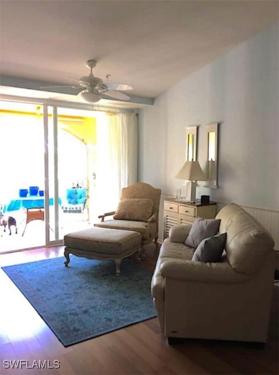 living room featuring ceiling fan and wood-type flooring