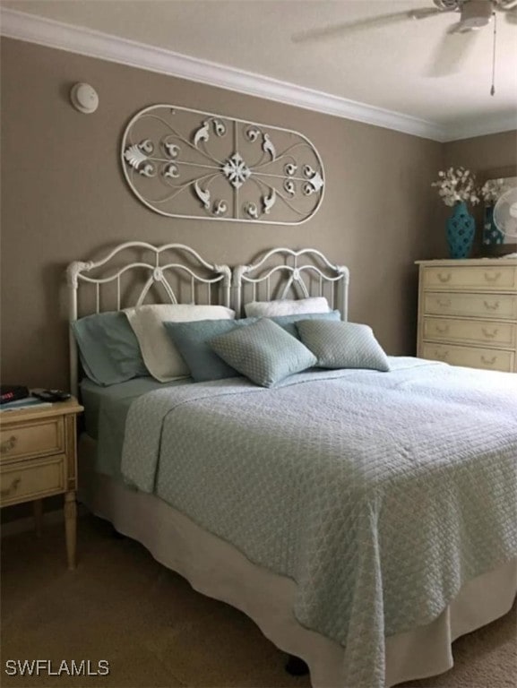 carpeted bedroom with crown molding and ceiling fan