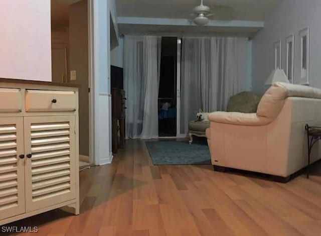 living area with ceiling fan and hardwood / wood-style flooring