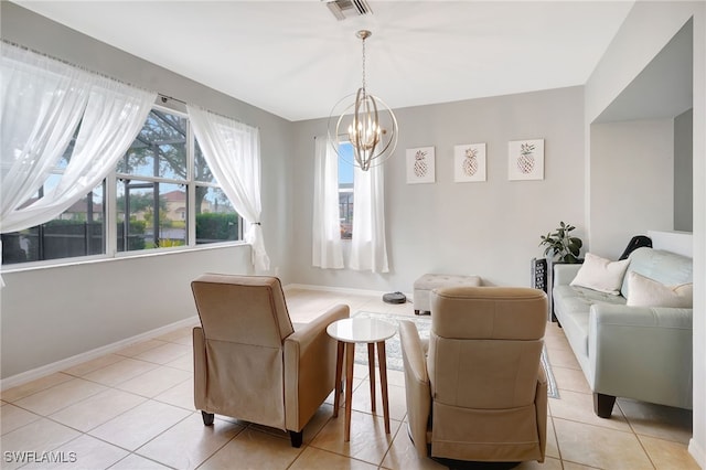 sitting room featuring a notable chandelier and light tile patterned flooring