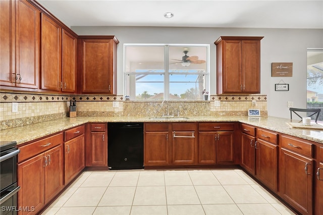 kitchen with decorative backsplash, light stone counters, light tile patterned floors, dishwasher, and sink