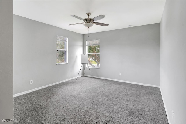 carpeted spare room with ceiling fan