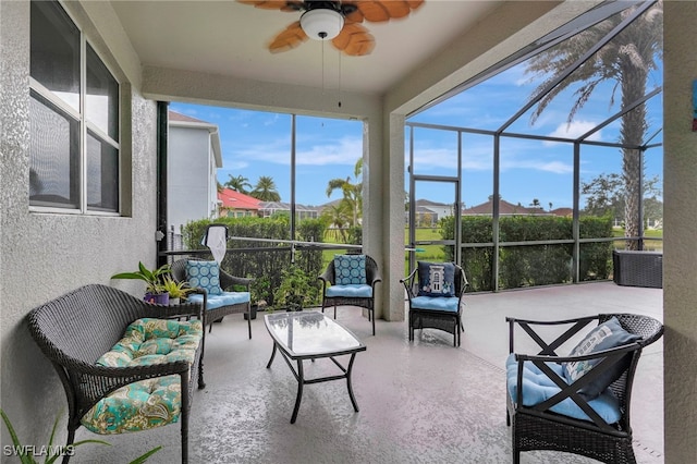 sunroom featuring ceiling fan