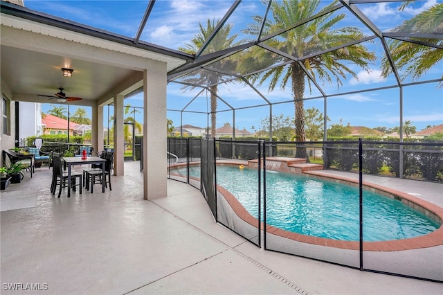 view of pool featuring ceiling fan, glass enclosure, and a patio area