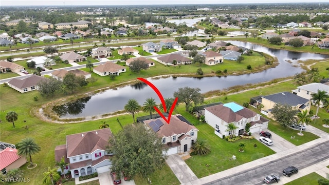 birds eye view of property with a water view