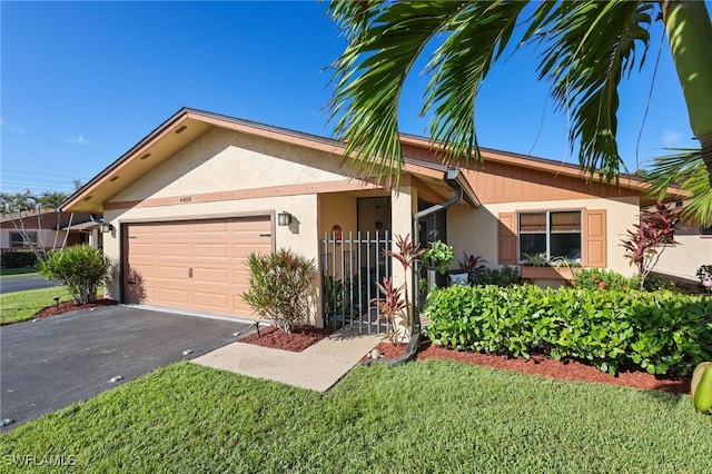 single story home with a front lawn and a garage