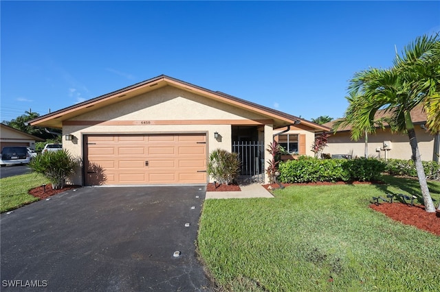 single story home featuring a front yard and a garage