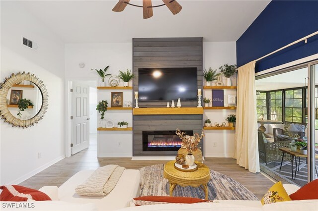 living room featuring ceiling fan and hardwood / wood-style floors