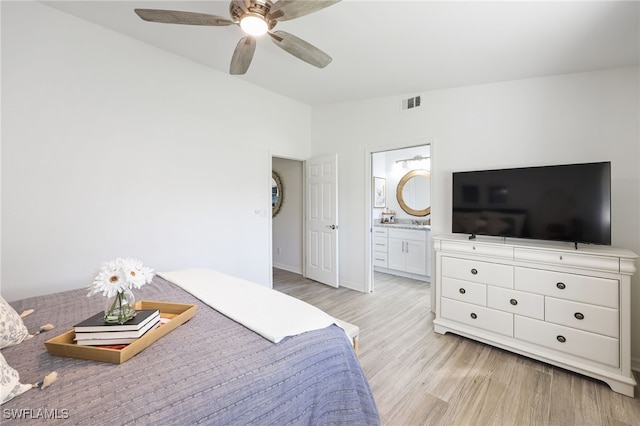 bedroom featuring ensuite bathroom, light hardwood / wood-style floors, and ceiling fan