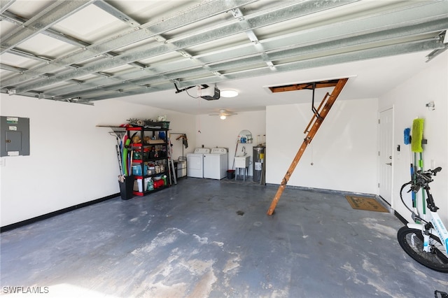 garage featuring sink, electric panel, washing machine and dryer, and a garage door opener