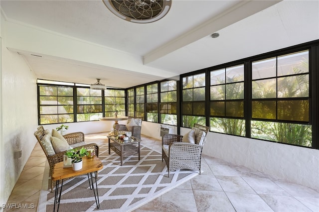 sunroom / solarium featuring beam ceiling