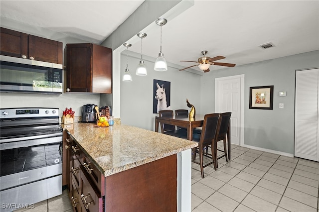 kitchen with stainless steel appliances, visible vents, a peninsula, and light tile patterned flooring