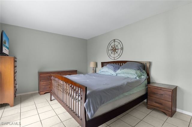 bedroom featuring light tile patterned floors and baseboards