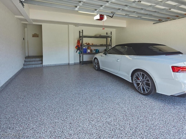 garage with a carport and a garage door opener