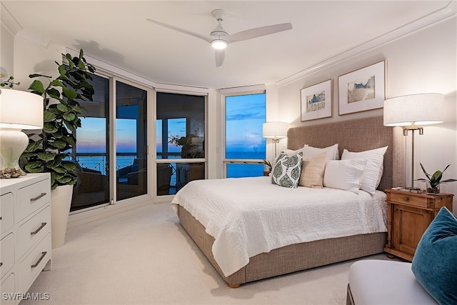 bedroom with ceiling fan, a water view, ornamental molding, and access to outside