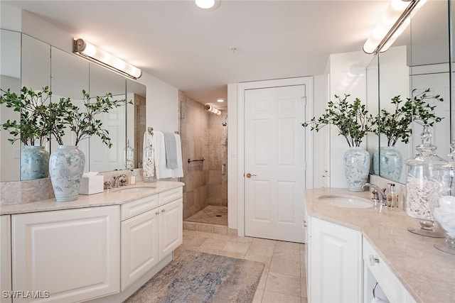 bathroom with tile patterned flooring, vanity, and walk in shower