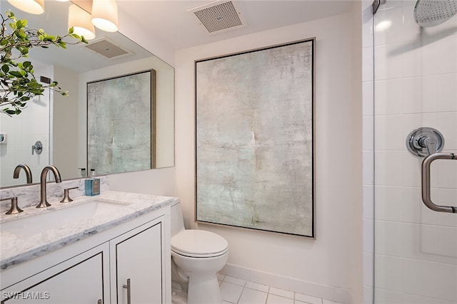 bathroom with tile patterned flooring, vanity, toilet, and an enclosed shower